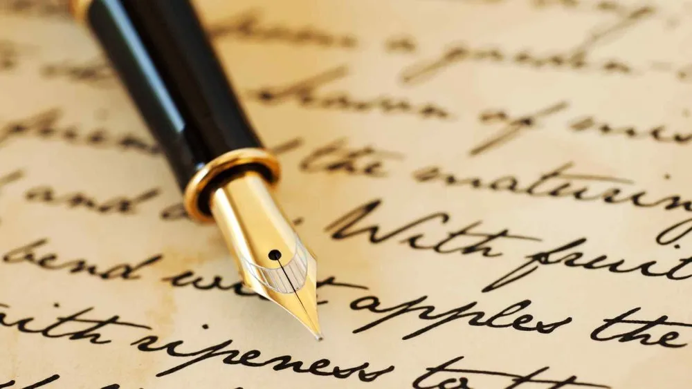 A fountain pen placed at the top of a sheet of paper
