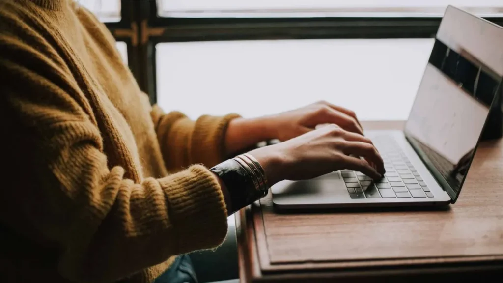 A writer typing her next blog