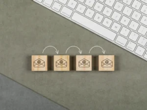 Lead nurturing email sequence represented by email icons on wooden cubes